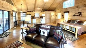 A cozy cabin interior with a living room, kitchen, and sleeping area. - Private and Perfect! - hot tub, king bed, fireplace - dog and motorcycle friendly Studio Cabin by RedAwning (Tellico Plains)
