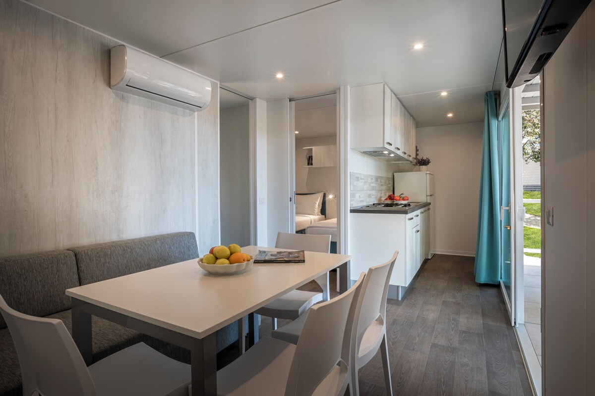 A modern kitchen with white cabinets and a grey countertop.