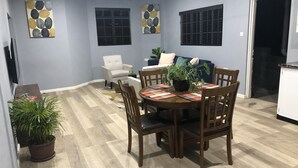 A dining area with a wooden table, chairs, and a potted plant. - The Island Experiences-Samo (Choiseul)