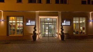A hotel entrance with two signs reading "WEINGUT SCHREI ECK" and a glass door leading inside.