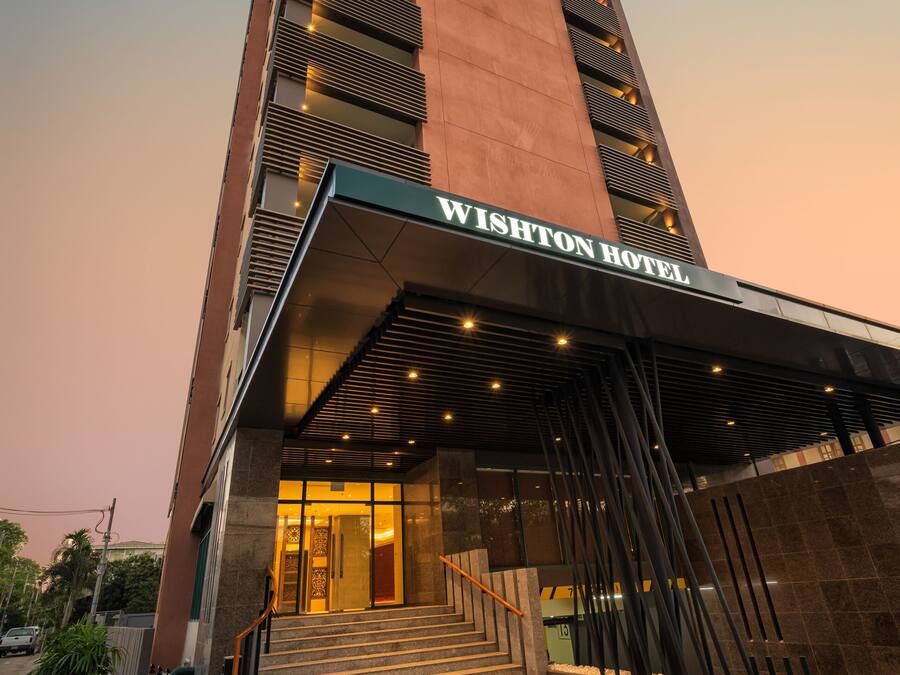 A modern hotel entrance with a prominent sign reading "WISHTON HOTEL".