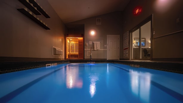 A swimming pool with a view of a door leading to a room. - Belamere Swimming Pool Suites (Cumming)