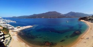 A coastal area with a marina, clear waters, and a beach. - Apartment with a panoramic view of the beach and the ocean (Propriano)