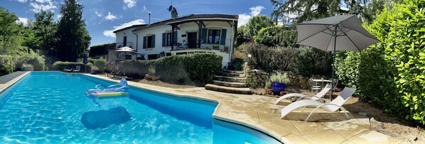A swimming pool with lounge chairs and a patio area. - Traditional French house with private pool and gardens. (Caylus)
