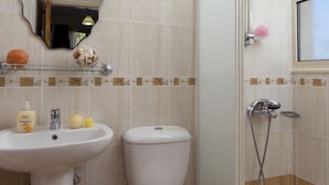 A bathroom with a pedestal sink, toilet, and a glass-enclosed shower area. - Luxury new villa on mountainside with private swimming pool & garden (Kathikas)