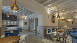 A modern interior with a bar area, seating, and a stone wall.