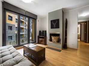 Relax in this stylish living room with a fireplace, flat-screen TV, and balcony access.