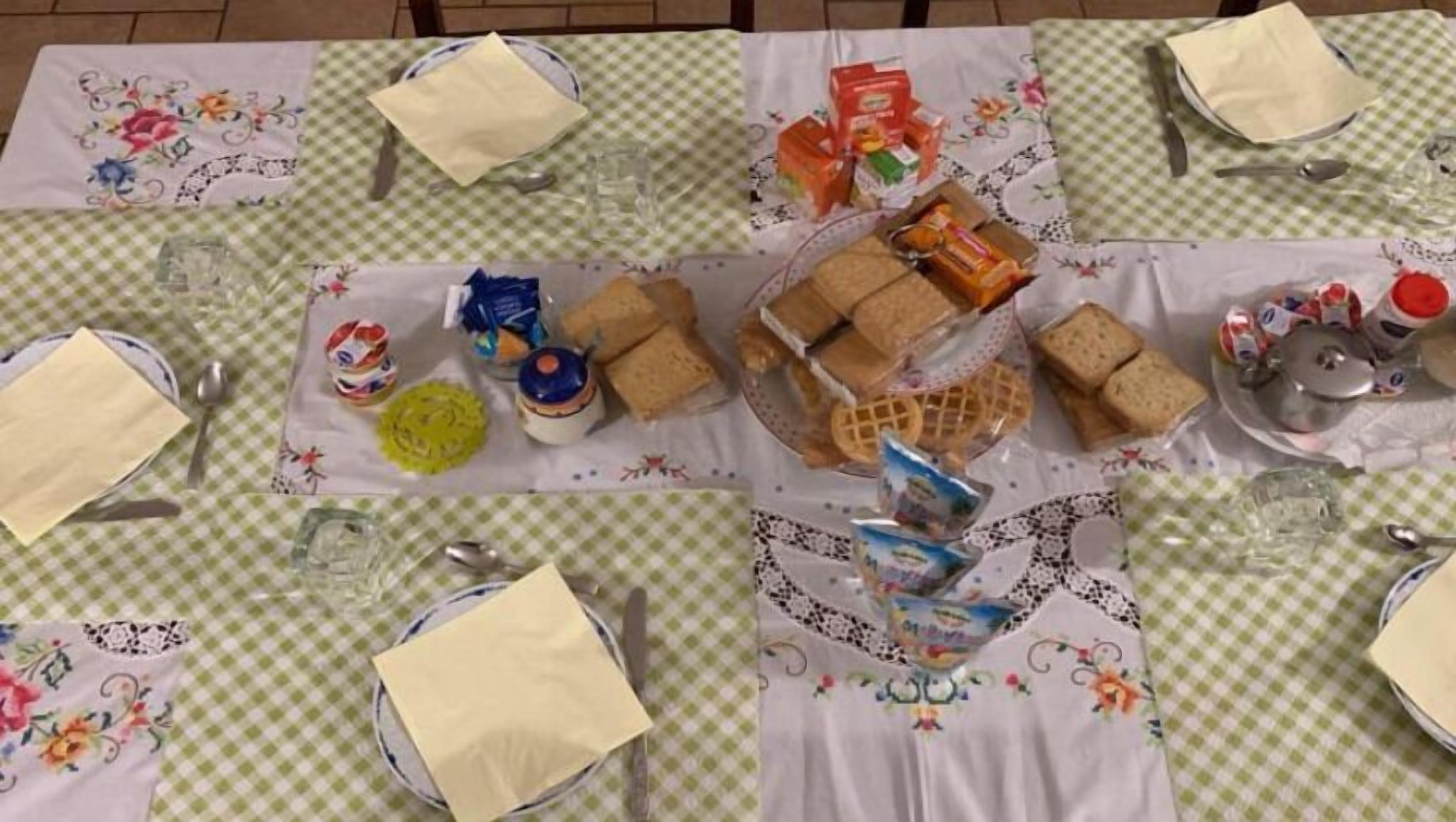 A table set for a meal with various food items and utensils.
