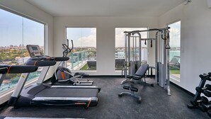A gym with treadmills, weight machines, and dumbbells. - Beautiful Apartment in Santo Domingo ** Pool and Gym (Julieta Morales)