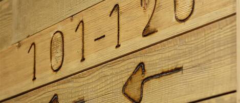 Wooden floorboards with numbers 101-120 and arrows pointing left.