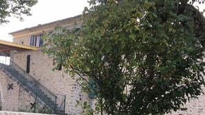 A stone sign with "Les Silves" inscribed, surrounded by grass and a tree, with a building and staircase in the background. - Stay in a 16th century three story home in the Provence countryside. (Mison)