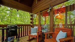 A wooden deck with two rocking chairs and a grill. - Time to Get Cozy! King Bed I Hot Tub I Foosball Table I Cabin for Couples (Sevierville)