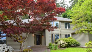 A two-story house with a front entrance, a pathway leading to the door, and a well-maintained lawn. - Luxurious Wine Country Estate with Mountain and Pastoral Views (Wilsonville)