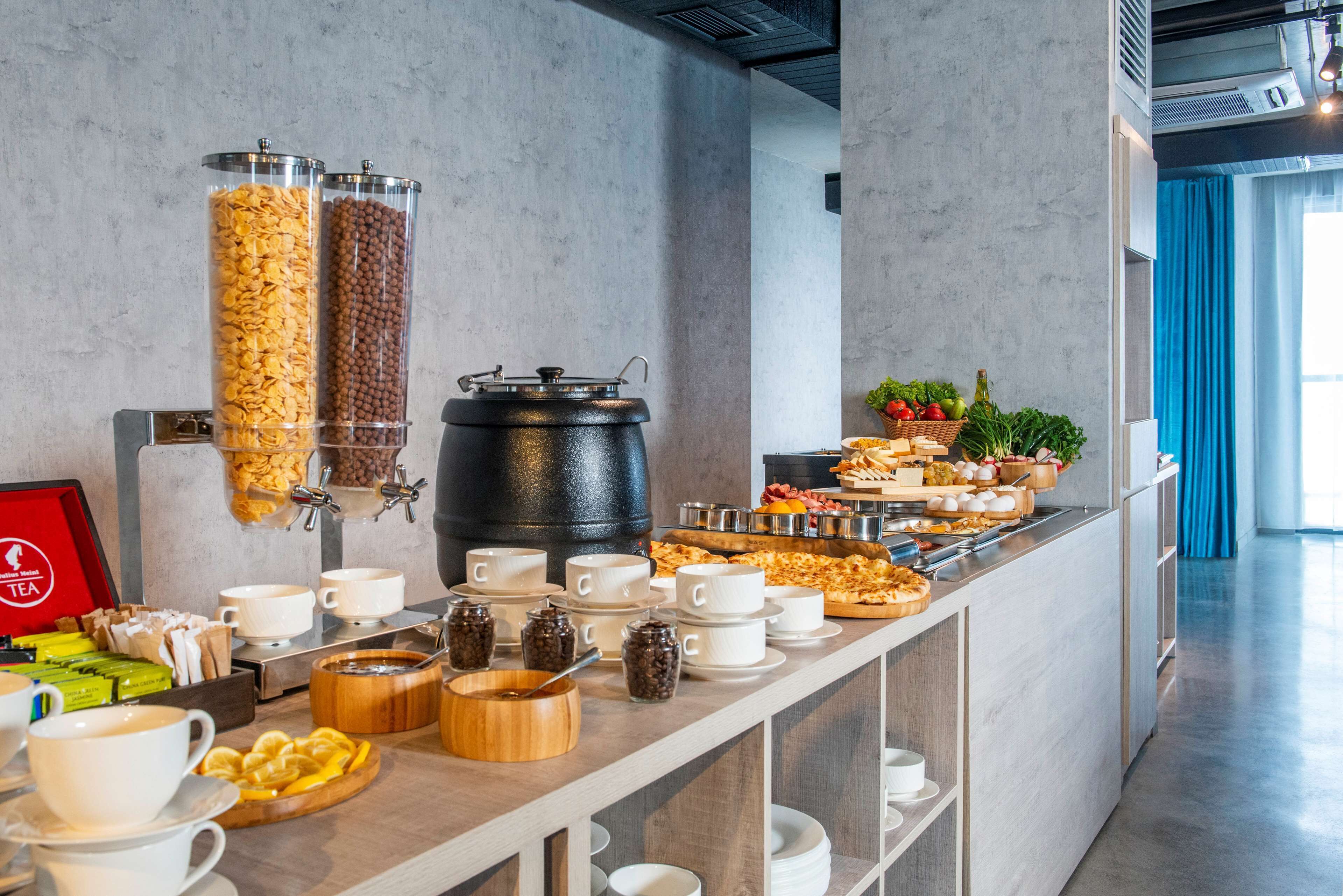 A buffet setup with various food items and beverages.