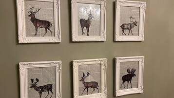 Six framed deer silhouettes on a wall.