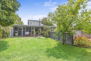 A residential property with a fenced backyard, a patio area, and a small garden. - The Beach House Anglesea (Anglesea)