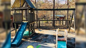 A playground with a slide and a swing set. - Once a Part of the Beloved Shady Oak Lodge - Cabin 3 w/ Boat Ramp (Many)