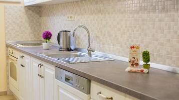 Deluxe Apartment, 2 Bedrooms | Private kitchen | Full-sized fridge, oven, stovetop, coffee/tea maker