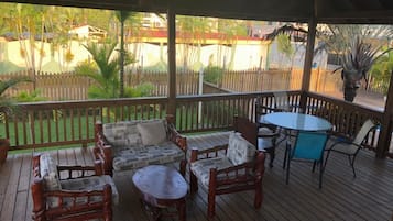 Relax on the outdoor deck with comfortable seating and a dining area.
