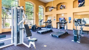 A gym with various exercise equipment, large windows, and a ceiling fan. - Ground Floor.Heated Pool! Hot Tub! Gas grill! 3 miles to Cardinal stad! 2 Kings! (Phoenix)