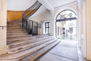 A staircase with ornate metal railings leading to a doorway. - Turn of the century elegance with a modern twist  II (V. kerület)