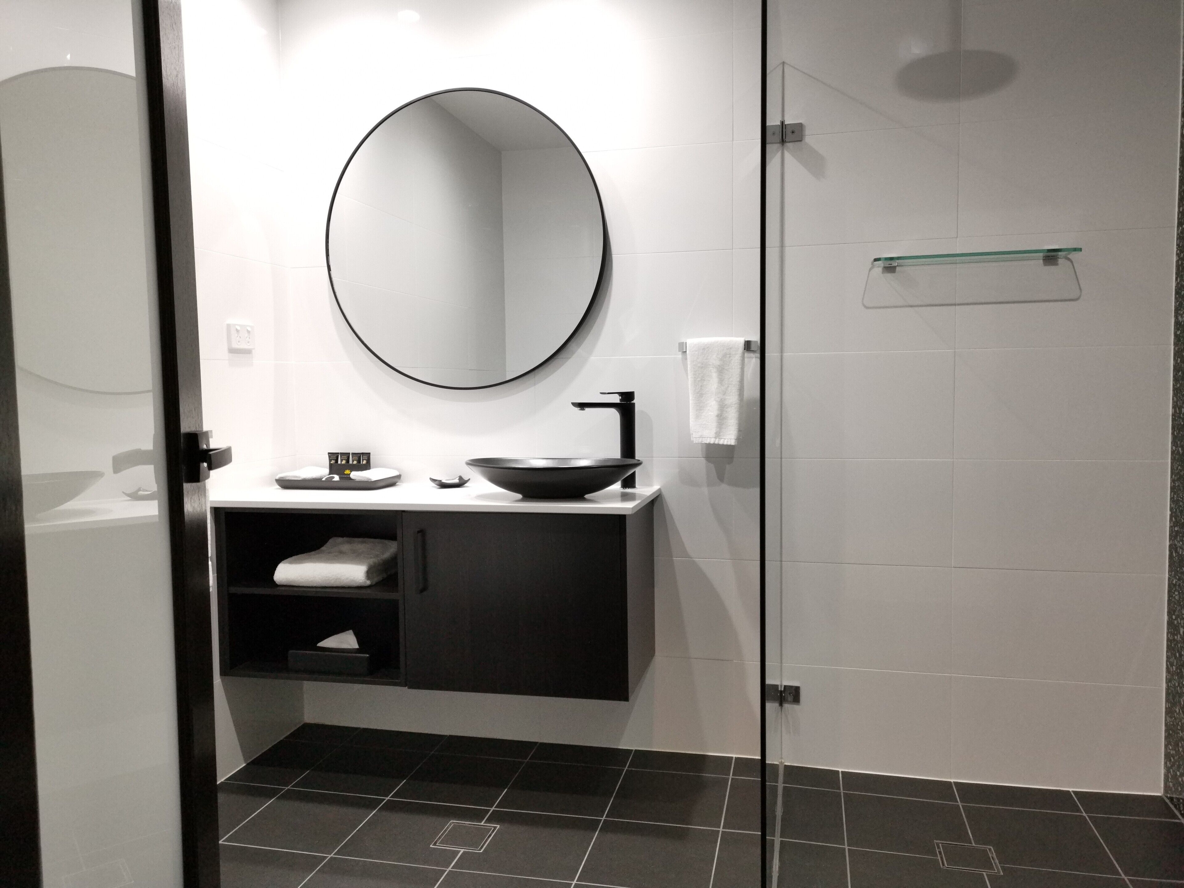 Shower, designer toiletries, hair dryer, towels