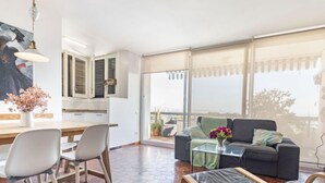A modern living room with a sofa, chairs, a coffee table, and a view of the outdoors. - Apartment Ursula by Interhome (Torredembarra)