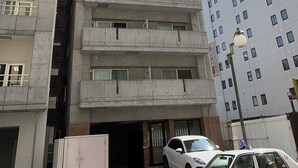 A multi-story building with a central entrance and a parking area. - IK Minami 6JO Residence 901 (Sapporo)