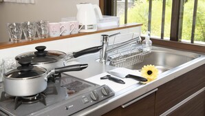 A kitchen with a stove, sink, and various kitchen items. - Miyakojima White House Annex (Miyakojima)