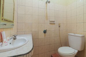 A bathroom with a sink, toilet, and shower. - Hotel O Astika (Ambon)