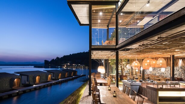 A waterfront restaurant with outdoor seating and a view of the water. - Z9 Resort (Si Sawat)