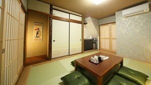 A traditional Japanese room with tatami flooring, a low wooden table with a tray of items, and sliding doors. - Asana-Yuuna (Kyoto)