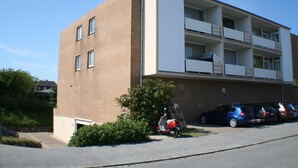 A multi-story building with a brick facade and white balconies. - Weber19 - Hammerich House (Wenningstedt-Braderup (Sylt))