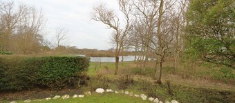 Charcoal burner at the village pond, Germany