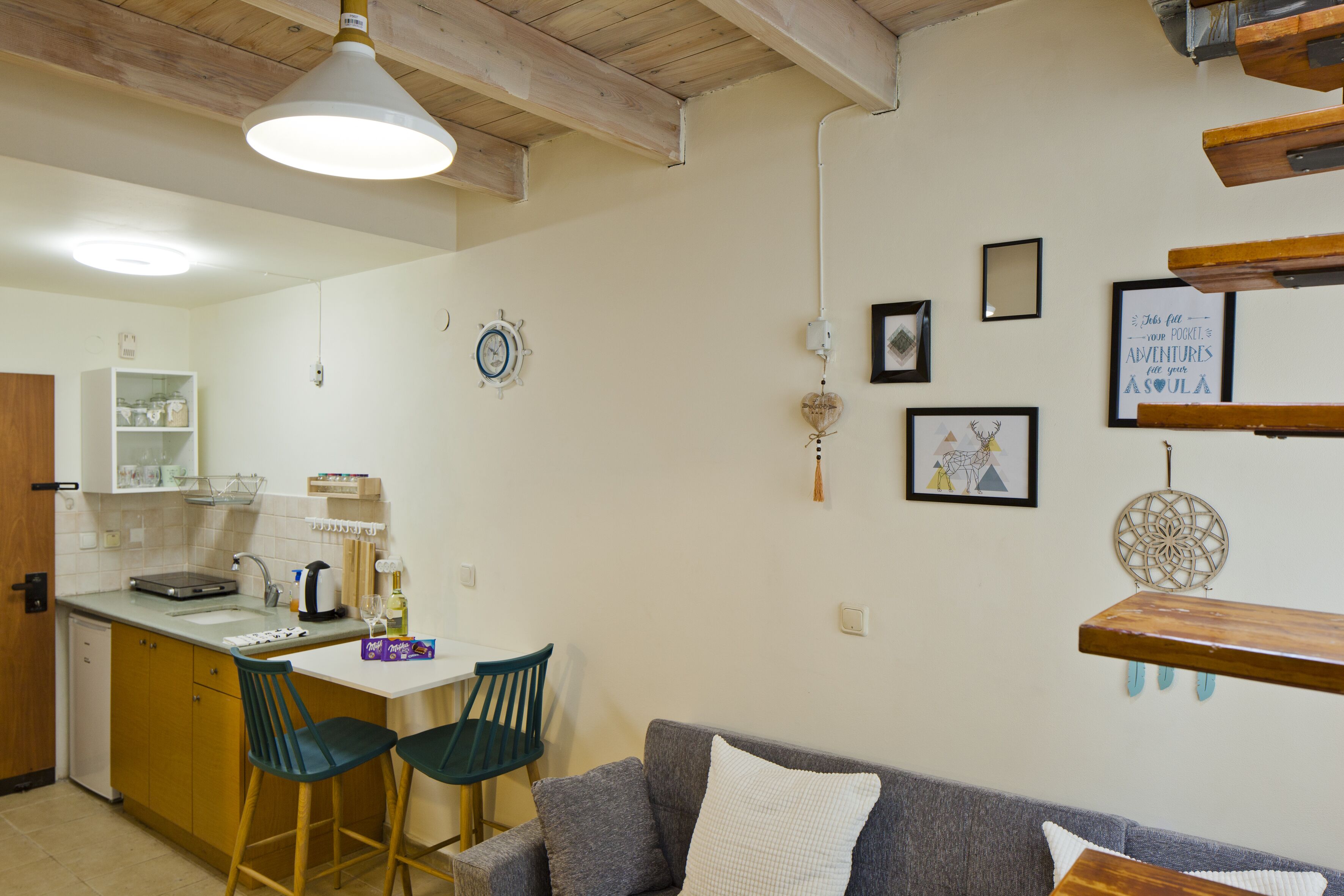 A compact living space with a kitchenette, a dining area, and a sofa.