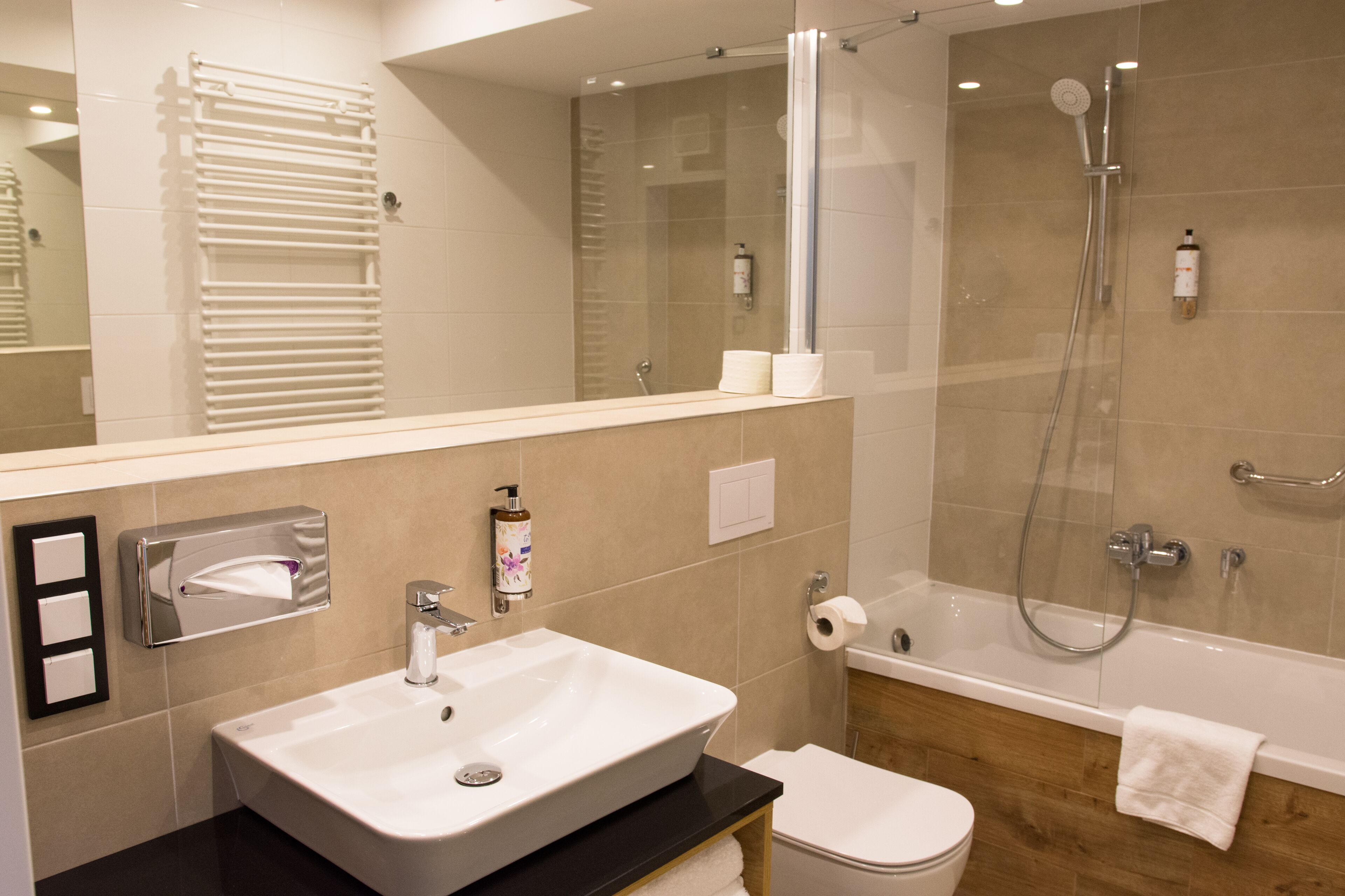 designer toiletries, hair dryer, bathrobes, slippers