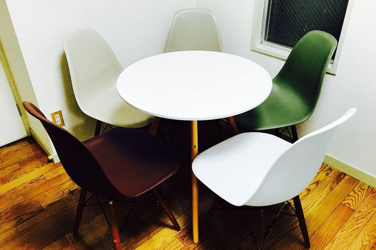 A small dining area with a round table and four chairs.