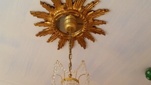 A chandelier with a sunburst design and crystal elements. - Hotel Robert Mayer (Frankfurt)