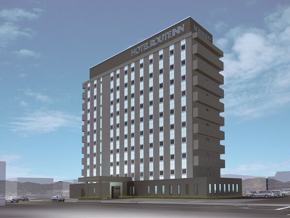 A modern hotel building with a sign reading "Hotel Route Inn." It features a multi-story structure with a uniform facade and a flat roof.