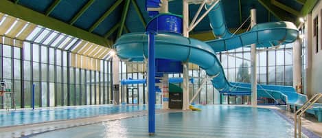 Enjoy a thrilling water slide experience in our spacious pool area.