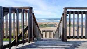 A wooden boardwalk leading to a beach with a clear view of the ocean and sandy dunes. - Steps from the Sand! Spacious Beach Home with Amazing Ocean Views! (Oceano)