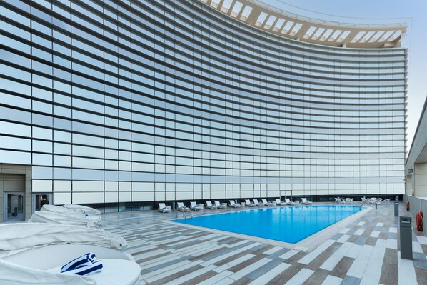 Outdoor pool, open 7:00 AM to 7:00 PM, pool umbrellas, pool loungers