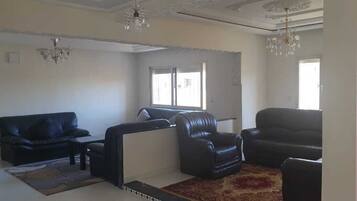 Apartment, 1 Bedroom | Living area | 32-inch flat-screen TV with satellite channels, TV
