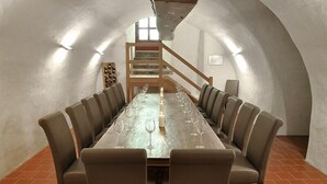 A dining room with a long table set for six, surrounded by six chairs.
