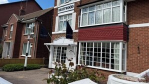 A two-story building with a sign reading 'DRIFTWOOD.' - Driftwood (Skegness)