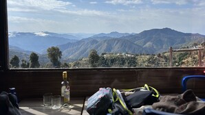 A room with a window overlooking a mountainous landscape. - Life Resorts (Tehri)