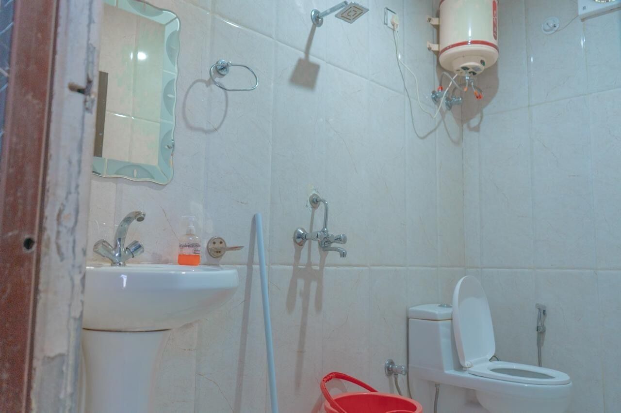 A bathroom with a sink, toilet, and shower.
