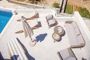 A rooftop pool area with lounge chairs, a sofa, and a round table. - Villa Nature Beauty with Heated Pool (Makarska)