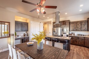 Enjoy cooking in this well-equipped kitchen with a central island, oven, and dining area.