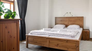 A wooden bed with a headboard, a bedside table, and a nightstand.